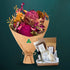 Hot pink dried native bouquet beside a five-piece Butler Bath pamper set in a kraft gift box with coffee scrub, clay mask, soap and flower bath, on dark teal